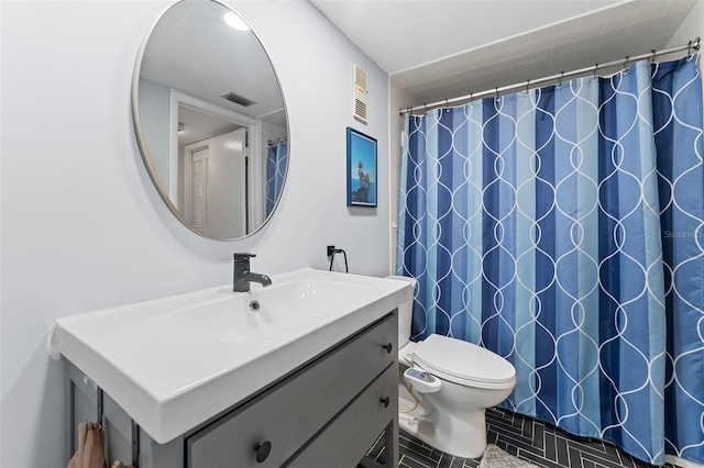 bathroom with tile patterned floors, vanity, toilet, and a shower with shower curtain
