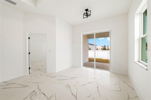 unfurnished room featuring a wealth of natural light