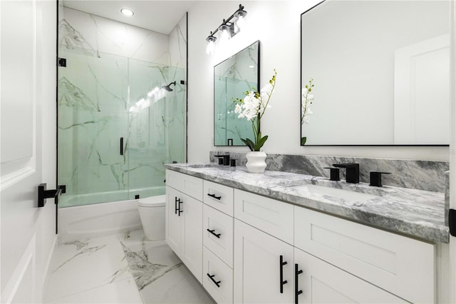 full bathroom featuring enclosed tub / shower combo, vanity, and toilet