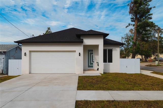 view of front of home featuring a garage and a front yard