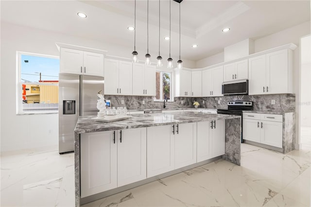 kitchen featuring appliances with stainless steel finishes, a center island, and white cabinets