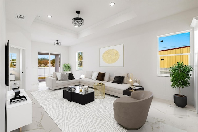 living room featuring crown molding and a tray ceiling