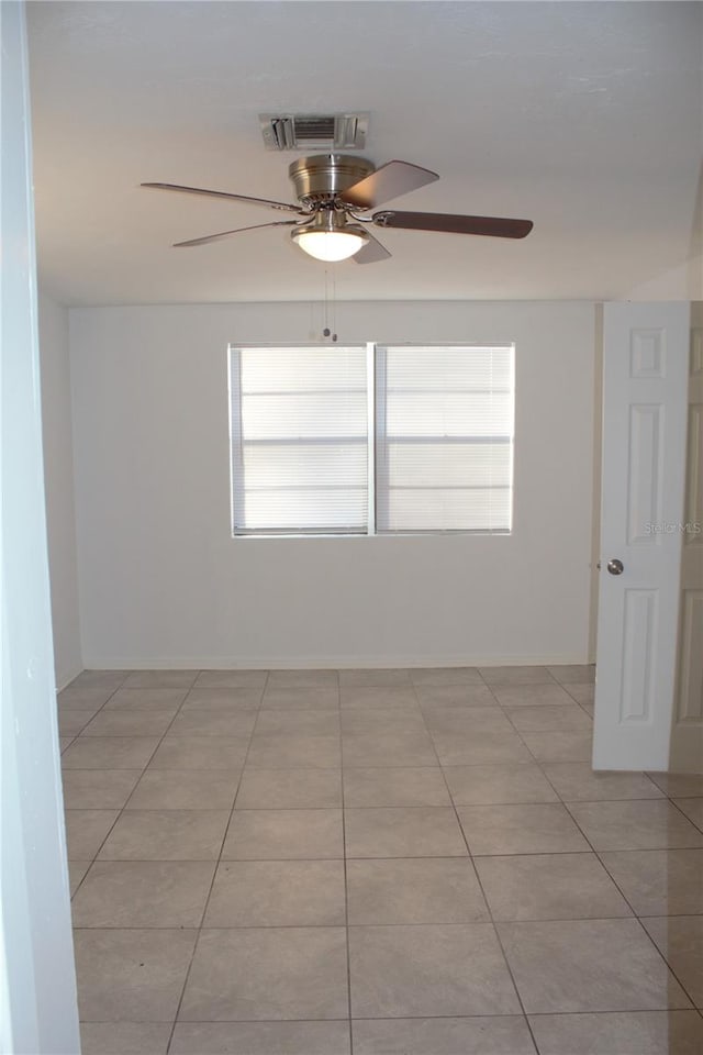 tiled empty room with ceiling fan