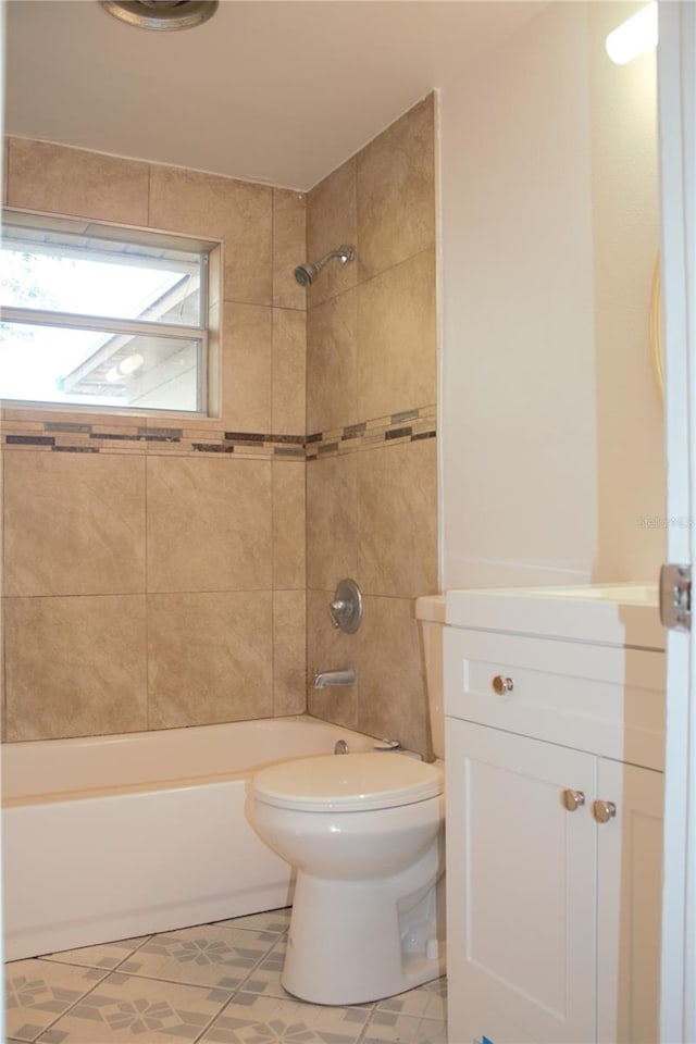 full bathroom featuring tile patterned floors, vanity, toilet, and tiled shower / bath