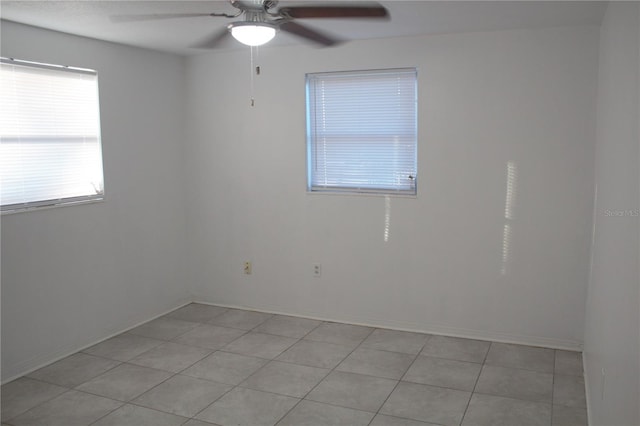 empty room featuring ceiling fan and light tile patterned floors