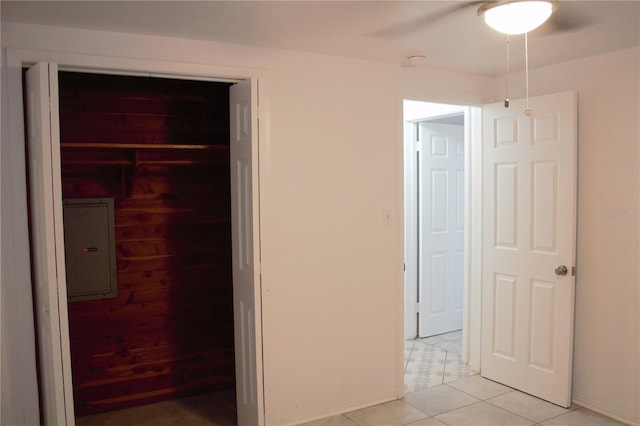 unfurnished bedroom with a closet, ceiling fan, and light tile patterned flooring