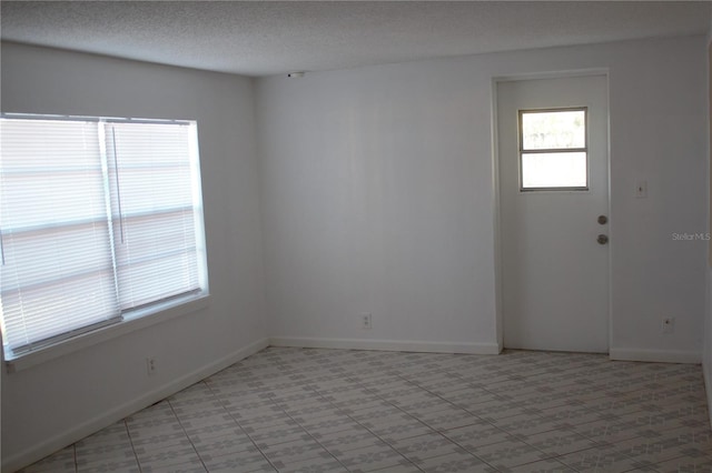 spare room featuring a textured ceiling