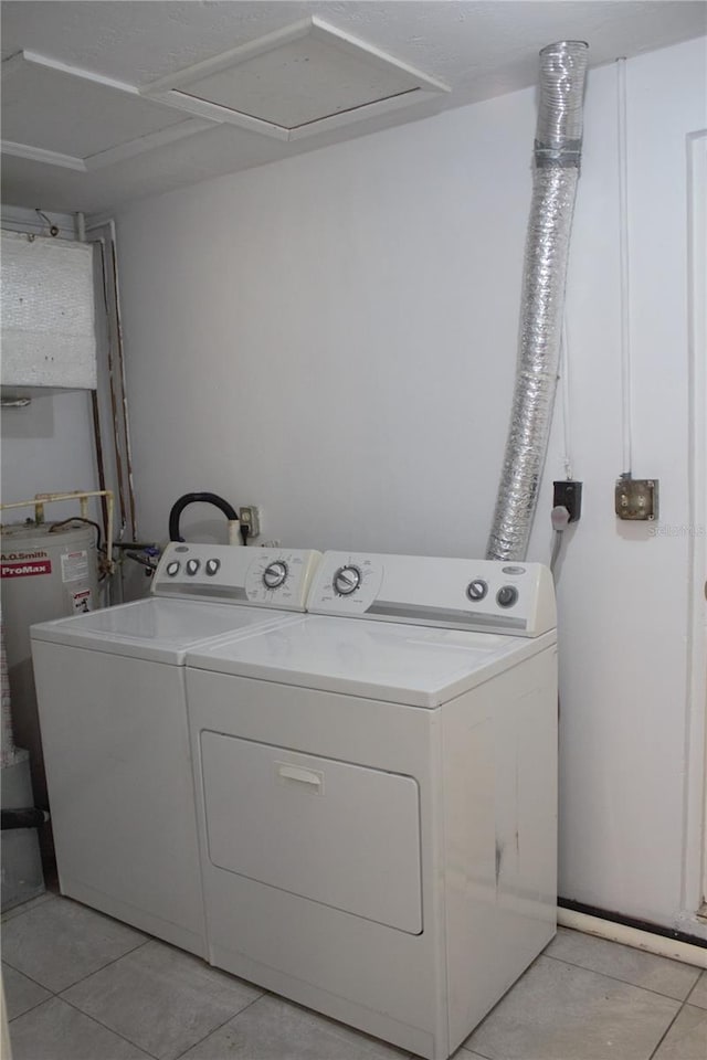 laundry room with separate washer and dryer and light tile patterned flooring