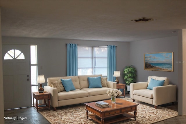 living room with tile patterned floors