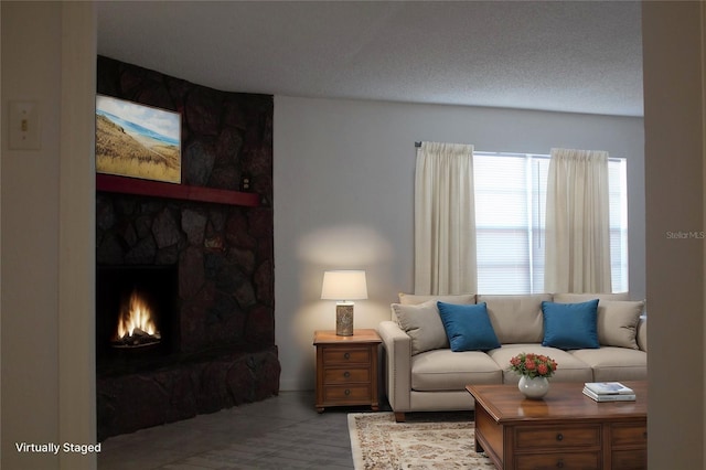 living room featuring a fireplace and a textured ceiling