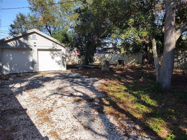 exterior space featuring a garage and an outdoor structure