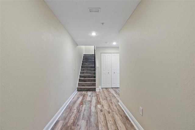 hallway with light hardwood / wood-style flooring