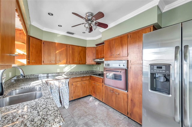 kitchen featuring appliances with stainless steel finishes, ornamental molding, ceiling fan, sink, and light tile patterned flooring