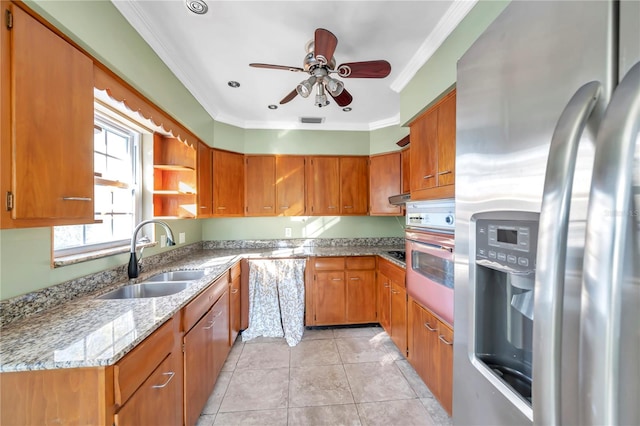 kitchen featuring light stone countertops, sink, stainless steel fridge, oven, and ornamental molding