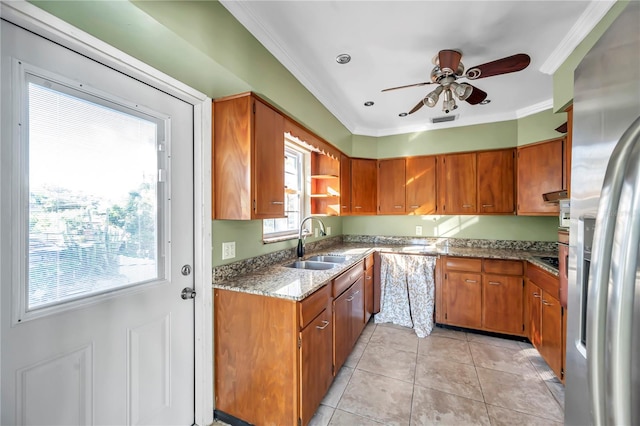 kitchen featuring stainless steel fridge, plenty of natural light, ornamental molding, and sink