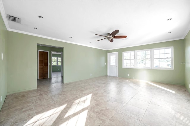 empty room featuring ceiling fan and crown molding