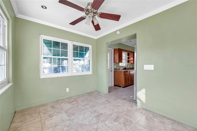 spare room featuring ceiling fan, sink, and crown molding