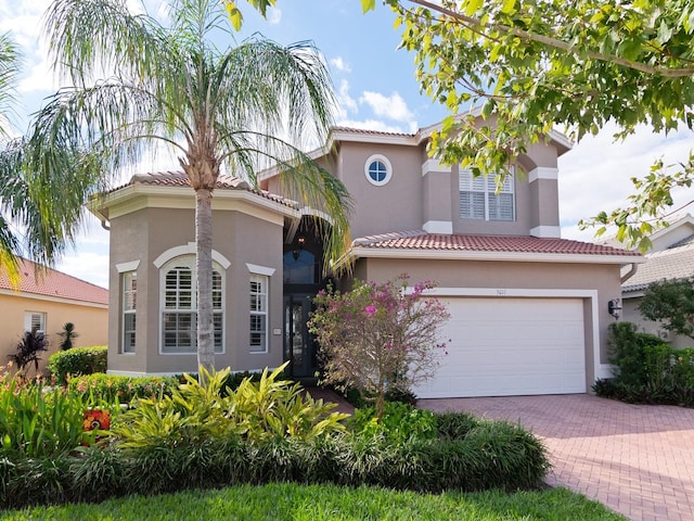 mediterranean / spanish-style home featuring a garage