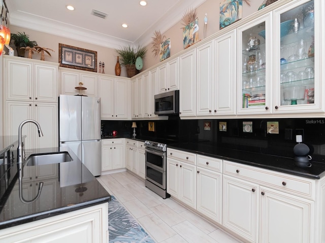 kitchen featuring backsplash, sink, white cabinets, and appliances with stainless steel finishes