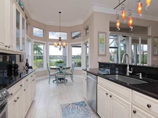 kitchen with pendant lighting, sink, stainless steel appliances, and an inviting chandelier