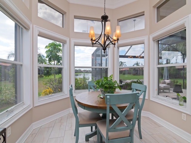 sunroom / solarium with a chandelier