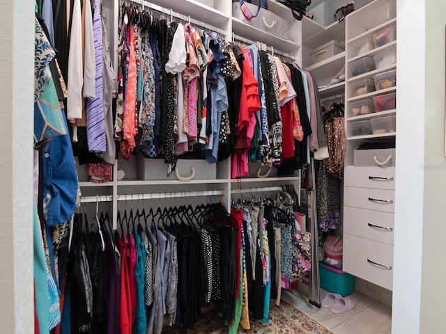 walk in closet with tile patterned floors