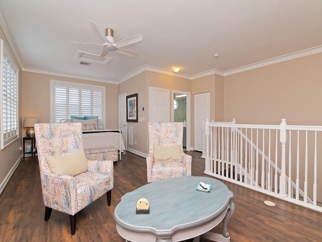 sitting room with ornamental molding, a textured ceiling, ceiling fan, and dark wood-type flooring