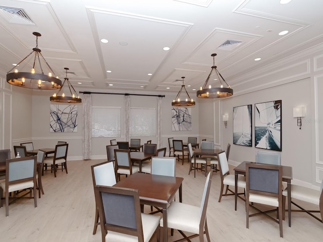 dining room featuring light wood-type flooring, crown molding, and coffered ceiling