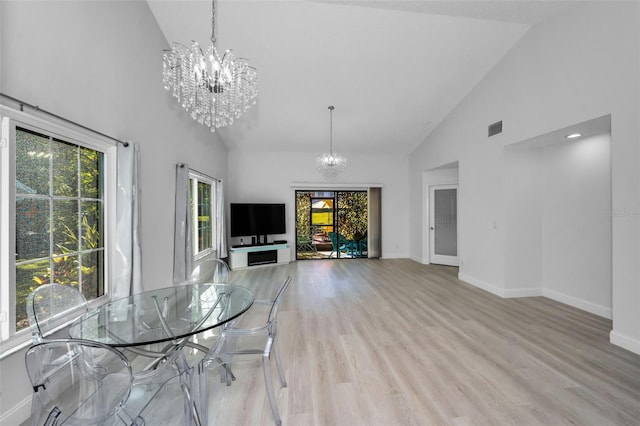 unfurnished dining area featuring light hardwood / wood-style flooring, high vaulted ceiling, and a healthy amount of sunlight