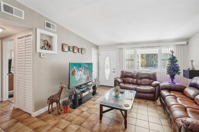 tiled living room with lofted ceiling