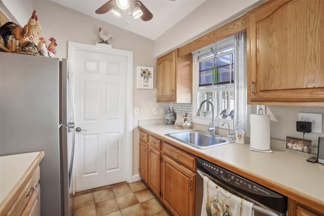 kitchen featuring ceiling fan, sink, vaulted ceiling, light tile patterned floors, and appliances with stainless steel finishes