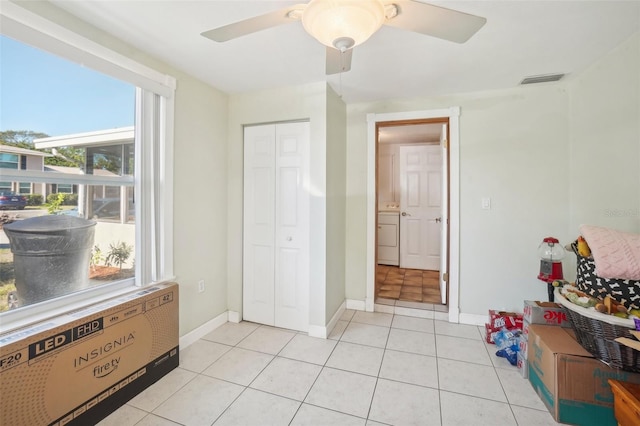 interior space featuring ceiling fan, a closet, and light tile patterned floors