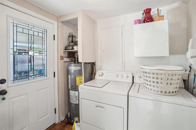 clothes washing area with washer and dryer and water heater