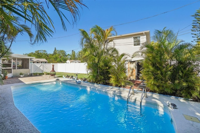 view of swimming pool with a sunroom