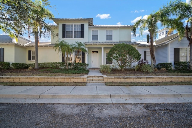 322 Ibisview Ln, Apollo Beach, FL 33572 - traditional-style home featuring stucco siding, metal roof, and a standing seam roof