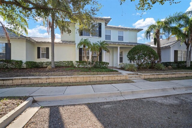 322 Ibisview Ln, Apollo Beach, FL 33572 - view of front of house featuring stucco siding and metal roof