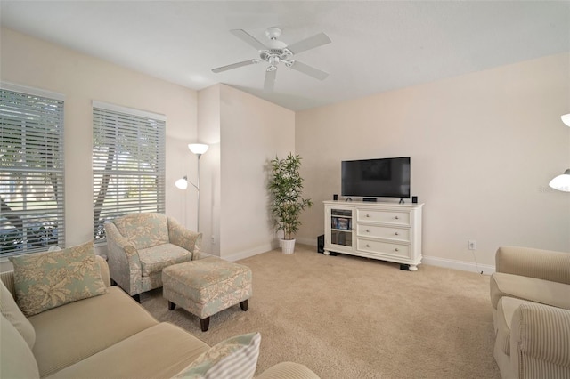 carpeted living room featuring ceiling fan