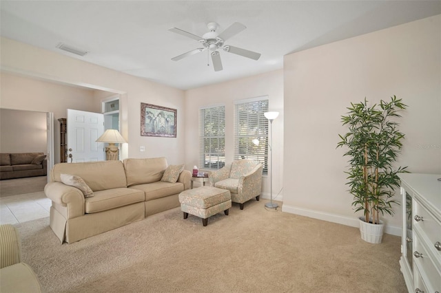 living room featuring light colored carpet and ceiling fan