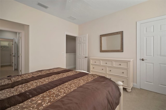 bedroom with light carpet and ceiling fan