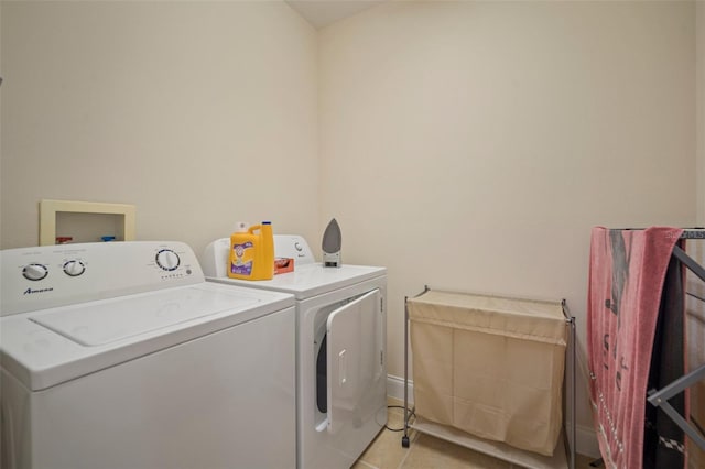 322 Ibisview Ln, Apollo Beach, FL 33572 - washroom with washer and dryer, light tile patterned floors, and baseboards