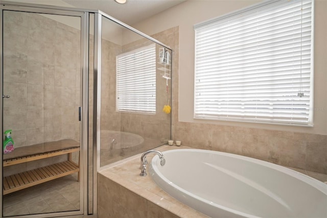 bathroom featuring independent shower and bath