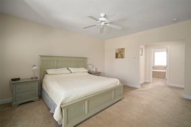 carpeted bedroom with a textured ceiling, ceiling fan, and ensuite bathroom