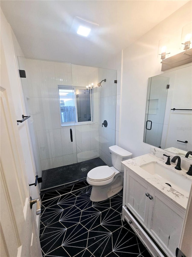 bathroom with tile patterned flooring, vanity, toilet, and a shower with door