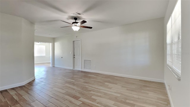 unfurnished room with light wood-type flooring and ceiling fan