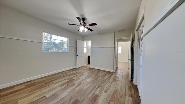 unfurnished bedroom with ceiling fan, light hardwood / wood-style floors, and a closet