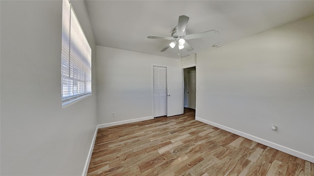 unfurnished room featuring ceiling fan and light wood-type flooring