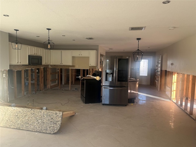 kitchen with a kitchen bar, white cabinetry, hanging light fixtures, and black appliances