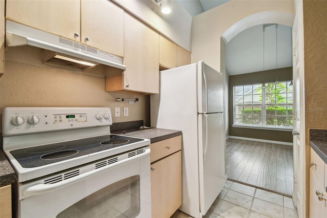 kitchen with light brown cabinetry, white appliances, light hardwood / wood-style flooring, and vaulted ceiling