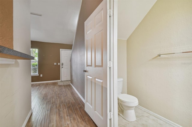 interior space with wood-type flooring and vaulted ceiling