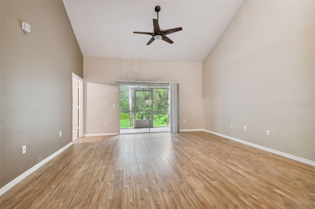 empty room with light hardwood / wood-style floors, high vaulted ceiling, and ceiling fan